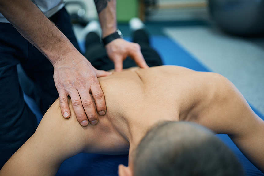 Therapist applying firm pressure during a sports massage session