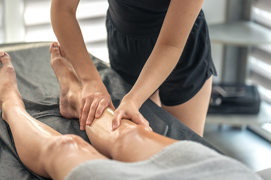 Sports massage therapist working with a client after training