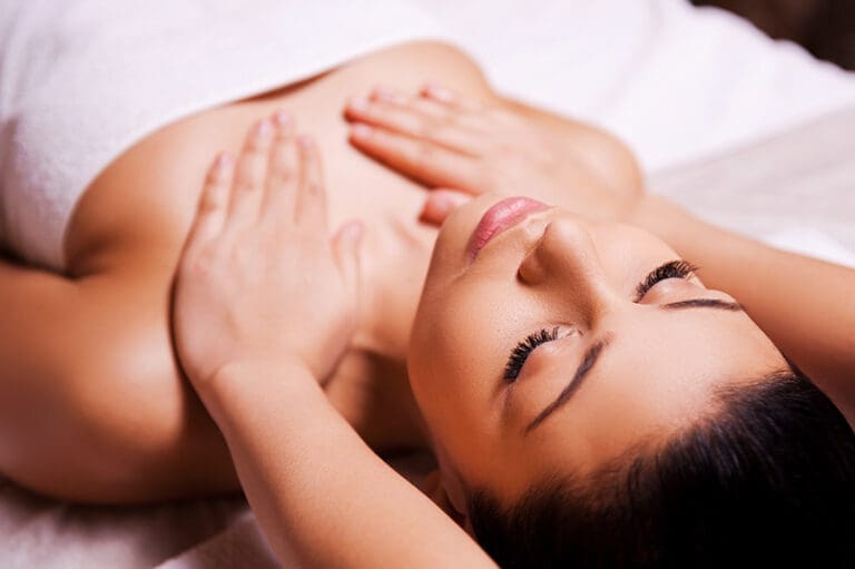 Pregnant woman considering gentle breast massage during pregnancy