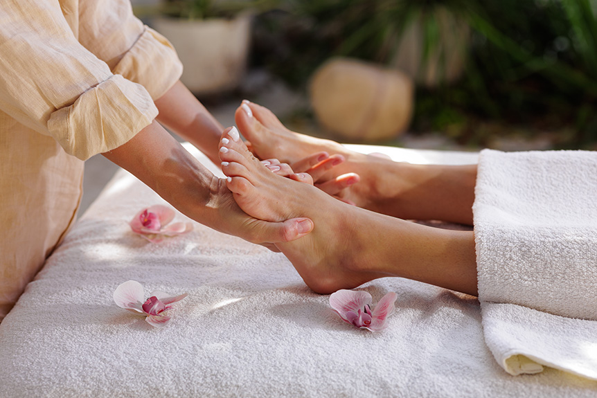 Therapist applying reflexology techniques to help manage diabetes symptoms