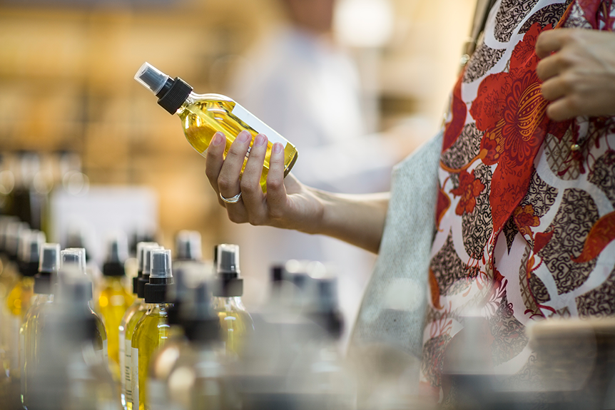 Therapist selecting from different bottles of massage oils