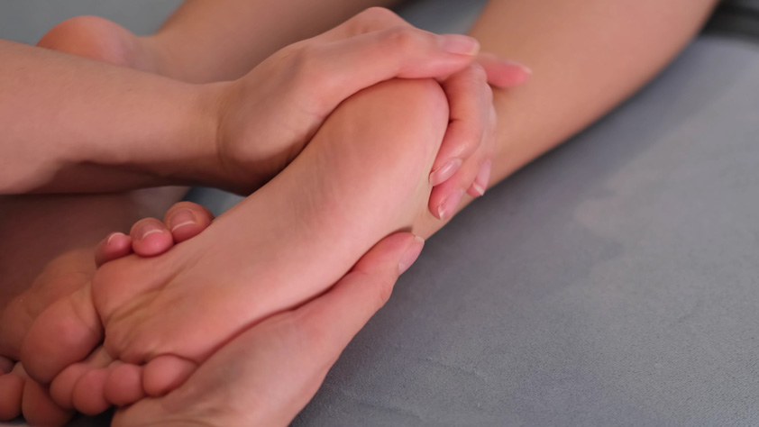 Mother is doing massage on her baby foot. Prevention of flat feet, development