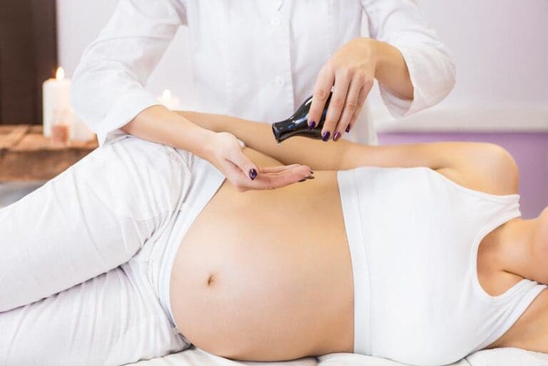 Pregnant woman have massage treatment at spa