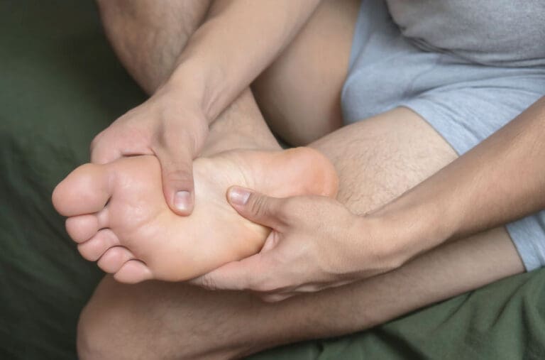 man massaging his foot