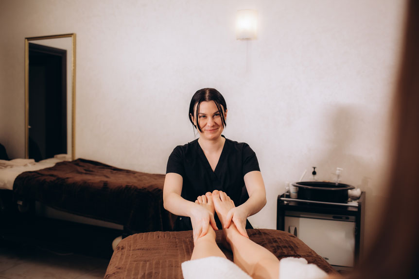 woman having reflexology foot massage