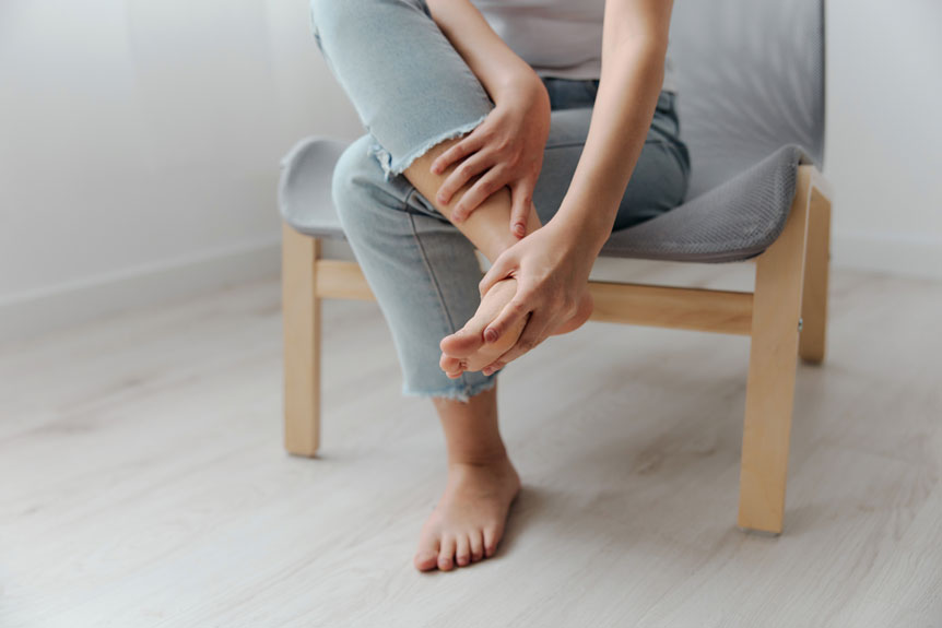 woman massaging her foot during break